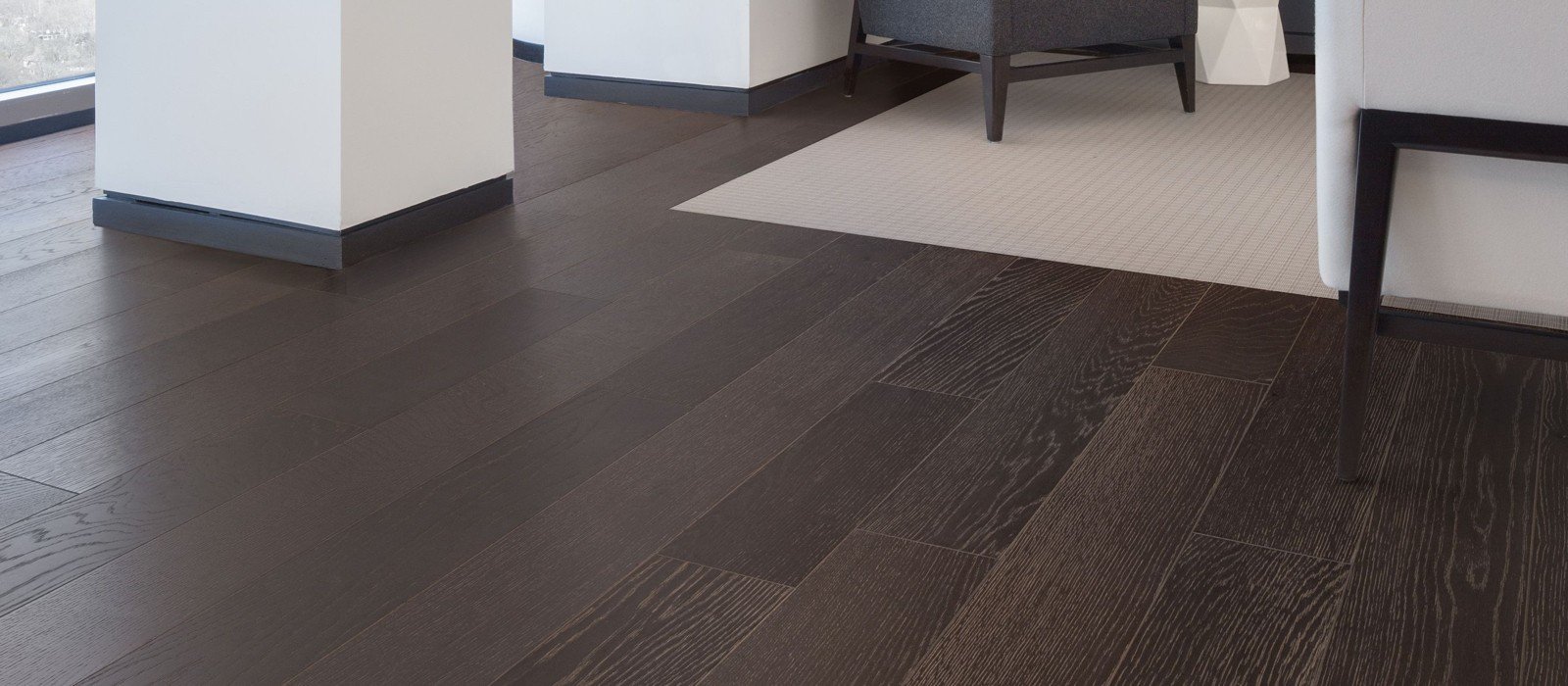 The interior of a living room with hardwood floors and carpet