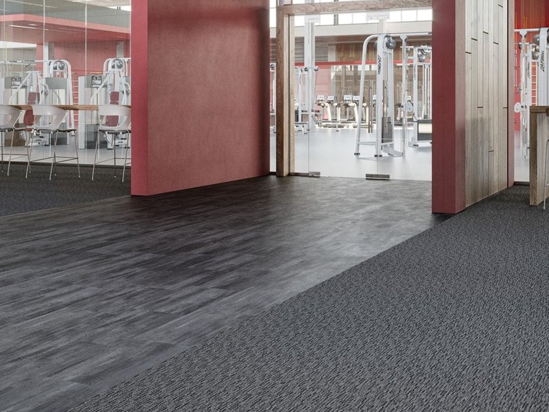 The interior of a commercial space with hardwood floors and carpeting.